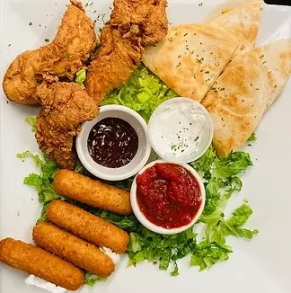 Platter of fried chicken, quesadillas, mozzarella sticks, lettuce, and sauces.