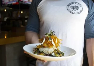 Plated fish or white meat, crispy golden topping, and white sauce.