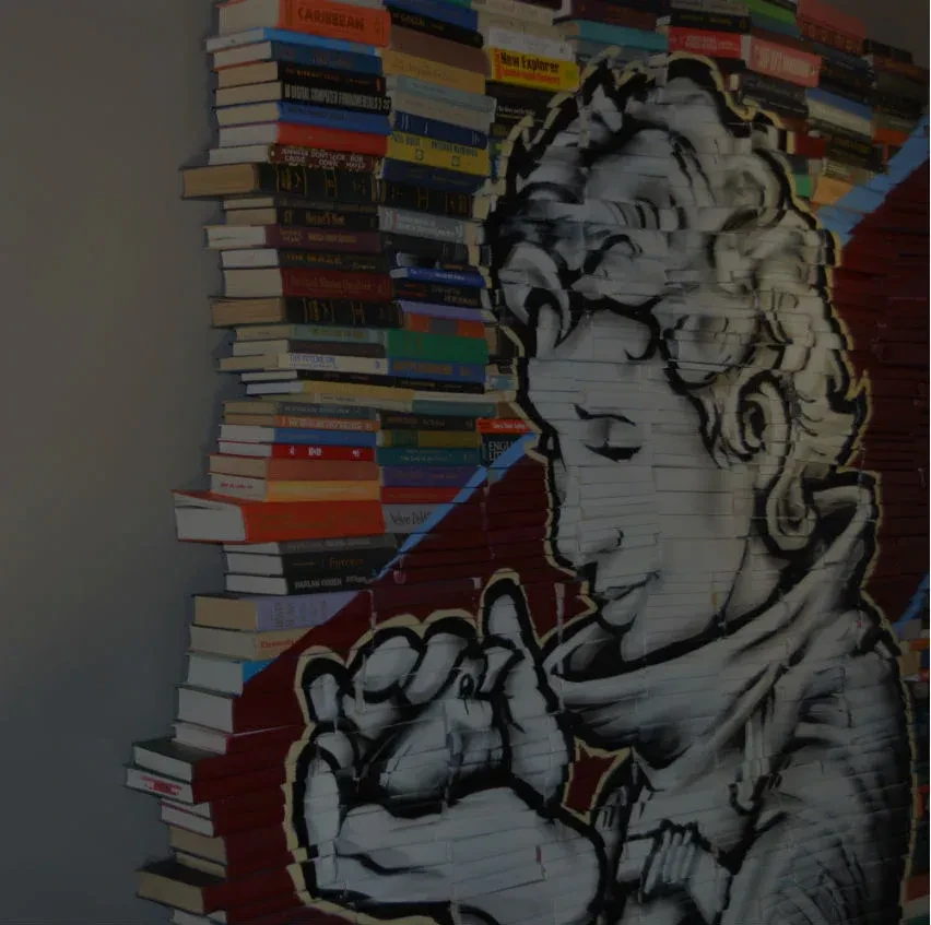 Vertical book stack and contemplative mural with a diagonal blue line.