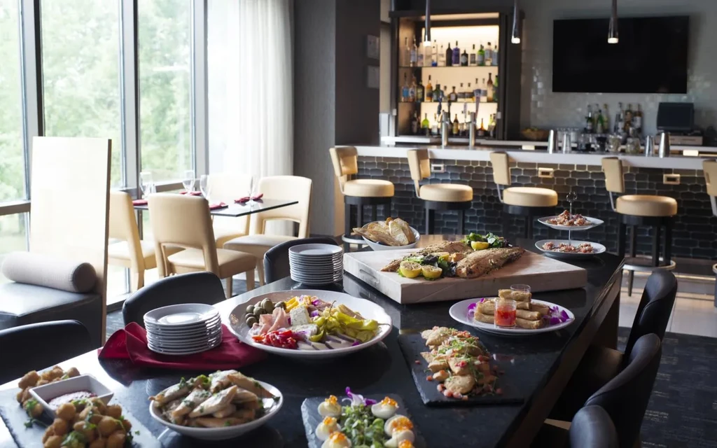 Modern restaurant buffet with extensive food spread and a stylish bar.
