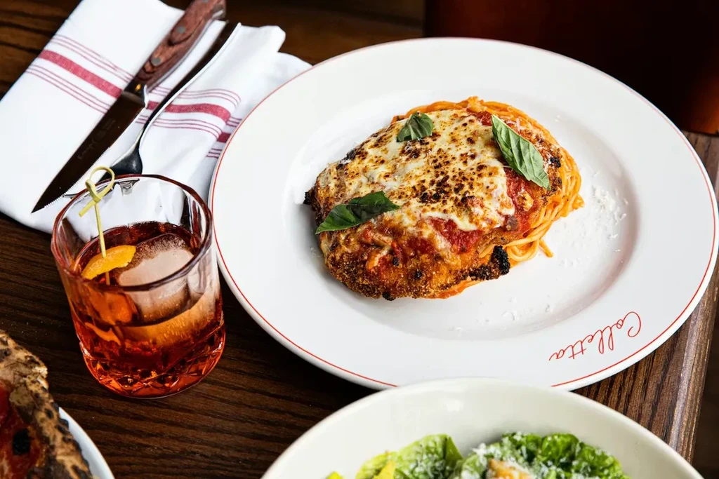 Colletta's parmesan with spaghetti, cocktail, salad, and pizza.