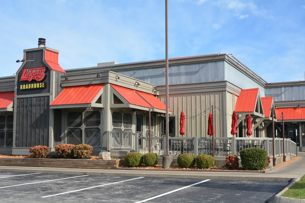 Logan's Roadhouse exterior: rugged building with red accents and patio.