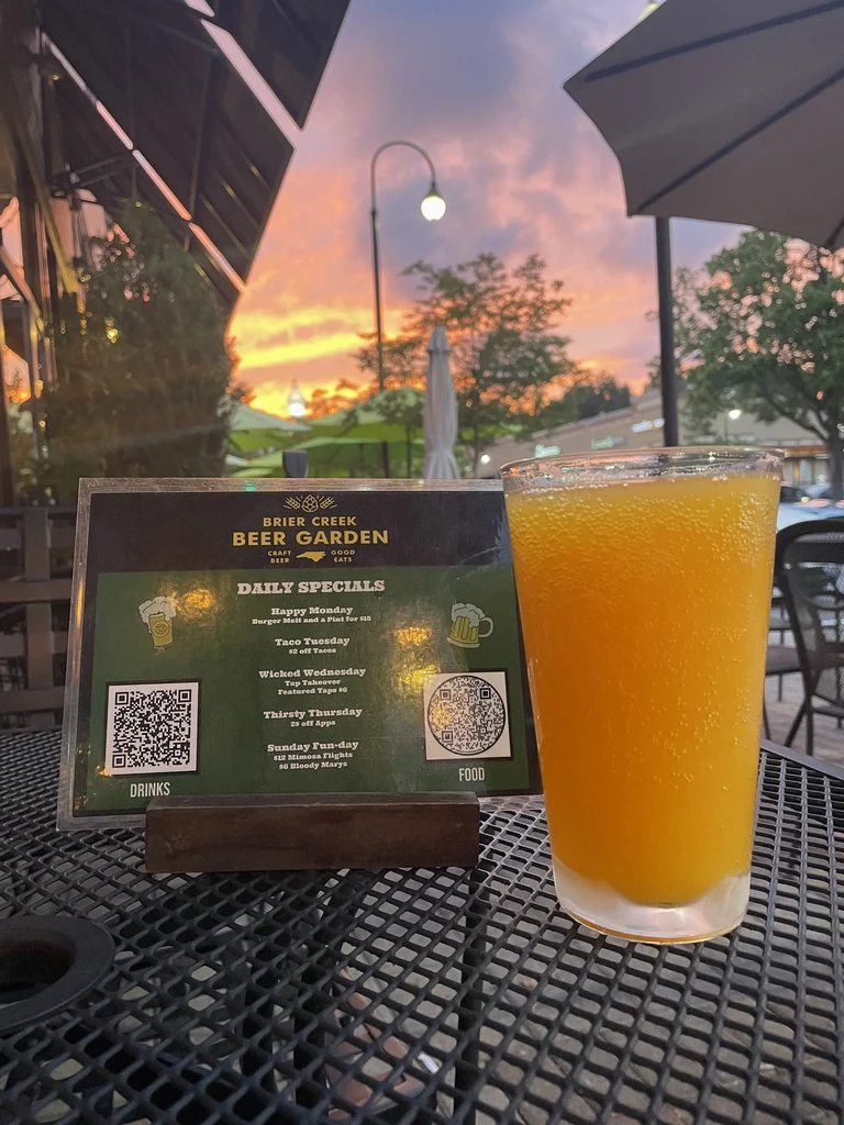 Brier Creek Beer Garden daily specials menu, orange drink, sunset.