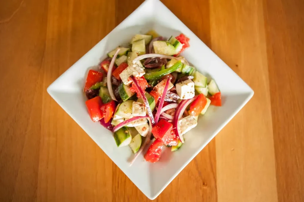 Vibrant Greek salad with diced vegetables, feta, and olives.