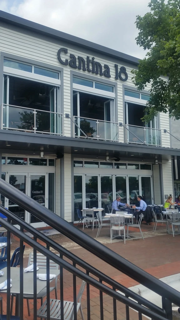 Modern two-story Cantina 18 restaurant with active outdoor dining patio.
