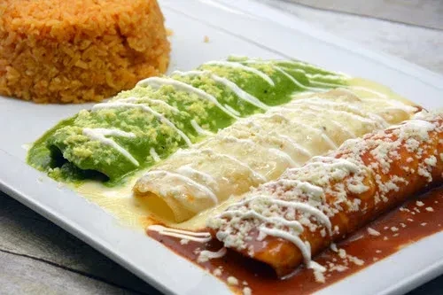 Three enchiladas with green, white, red sauces, cheese, and Mexican rice.