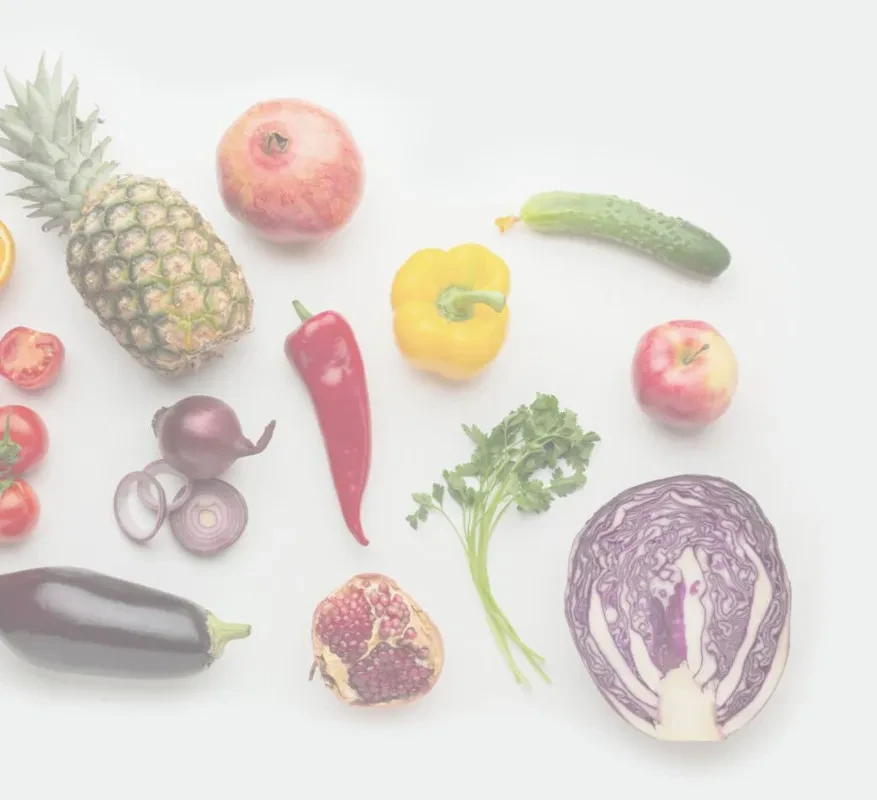 Flat-lay of fresh, colorful fruits and vegetables on white background.