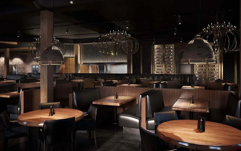 Dark, well-appointed restaurant dining room with chandeliers and wine display.