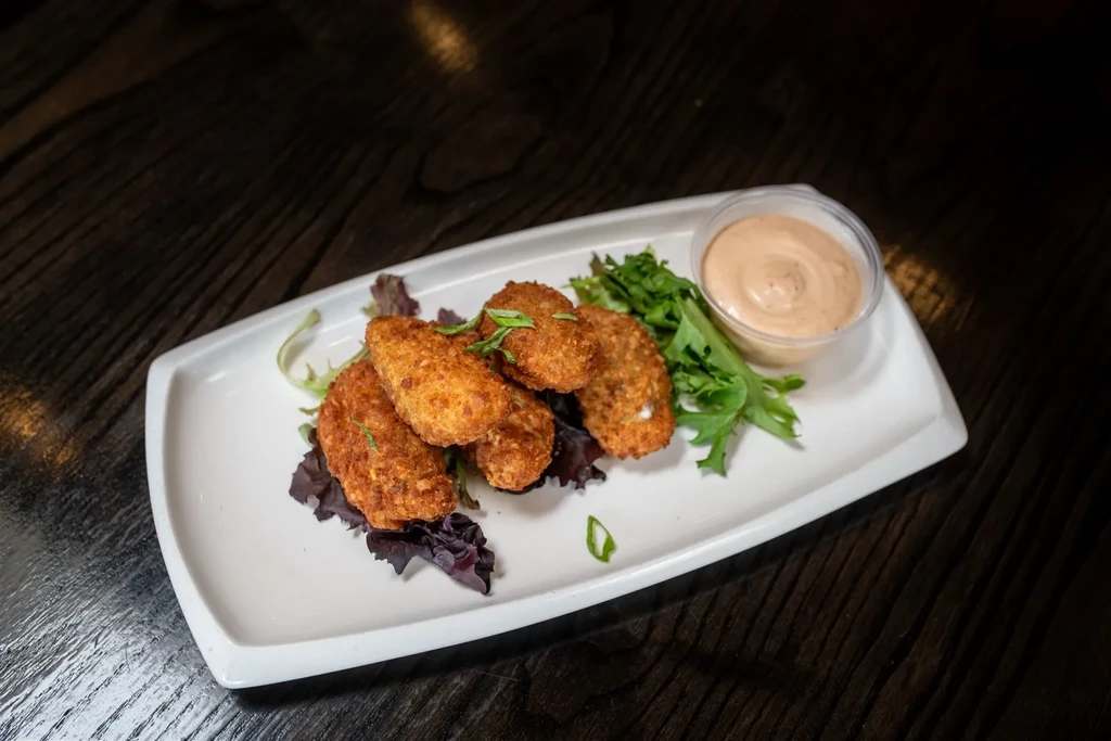 Four deep-fried appetizers with lettuce, herbs, and dipping sauce.