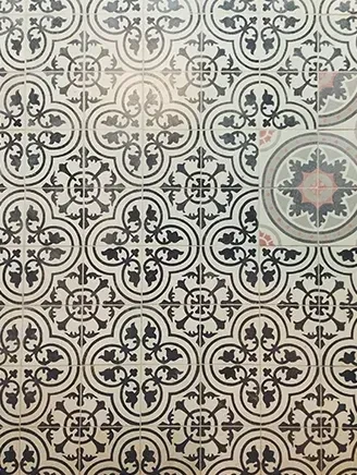 Ornate black and off-white ceramic tiles with floral and geometric designs.