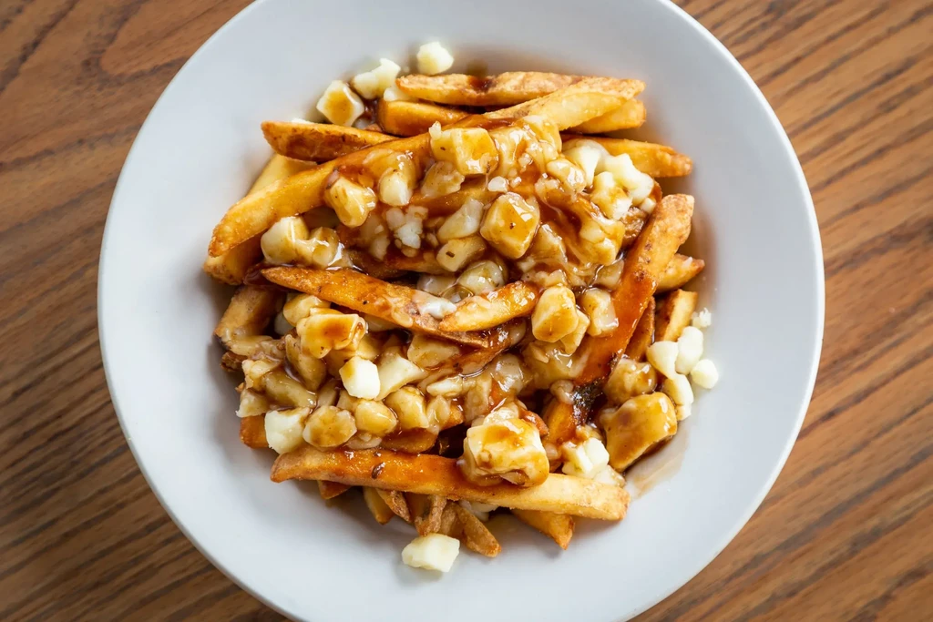 Poutine with golden fries, brown gravy, and melting cheese curds.
