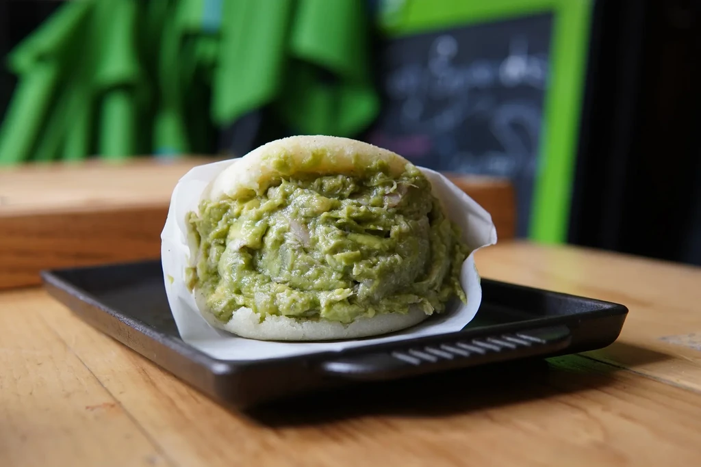 Arepa generously filled with creamy avocado chicken salad.
