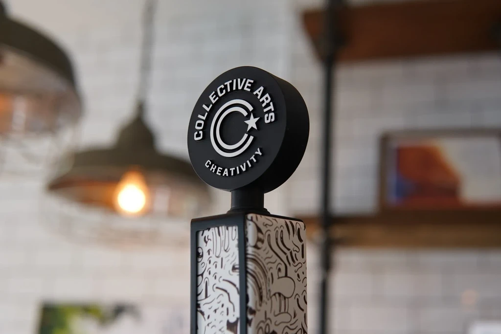 Collective Arts beer tap handle, black and white swirling pattern.