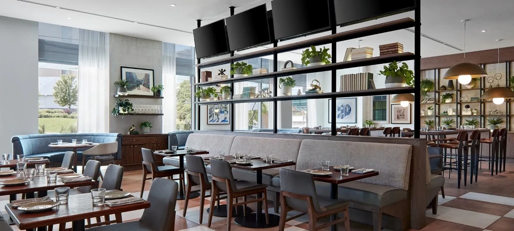Clean, modern restaurant interior with varied seating and decor.