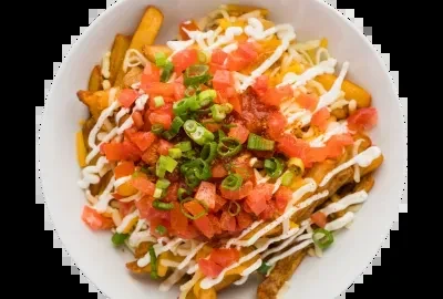 Loaded fries in white bowl with cheese, tomatoes, onions, and sauce.