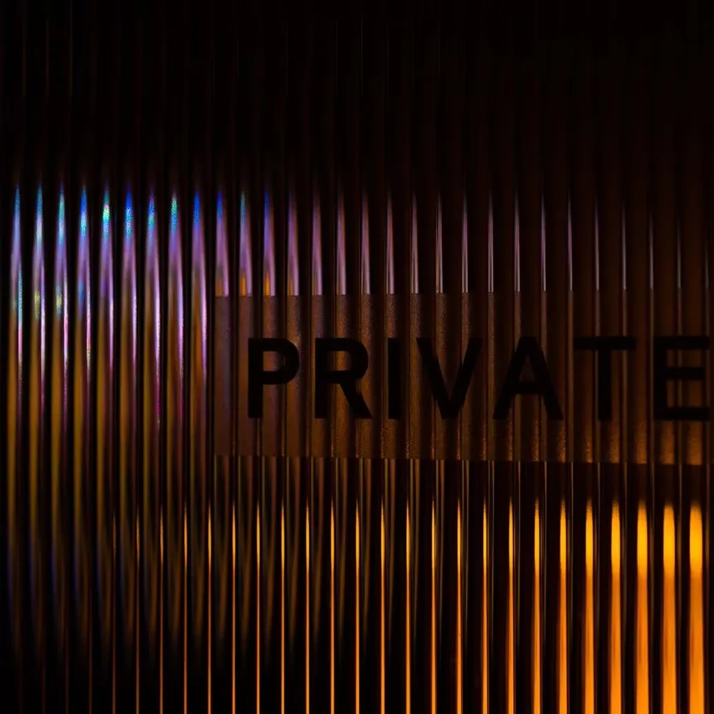Dimly lit ribbed panels show 'PRIVATE' in warm and cool hues.