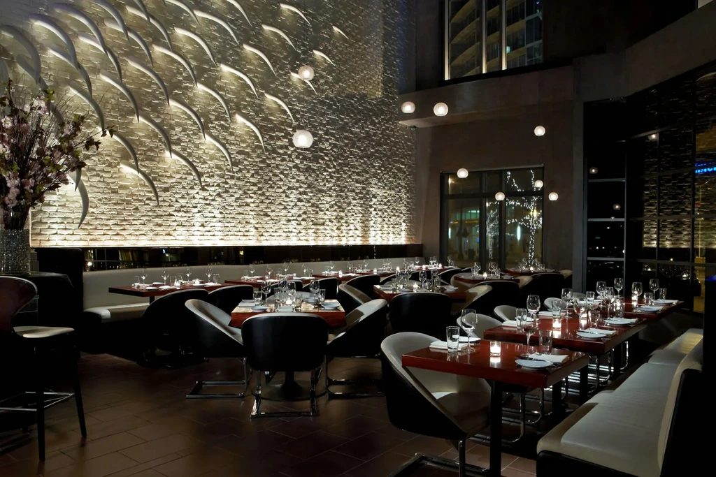 Upscale modern restaurant, empty with elegant decor and table settings.
