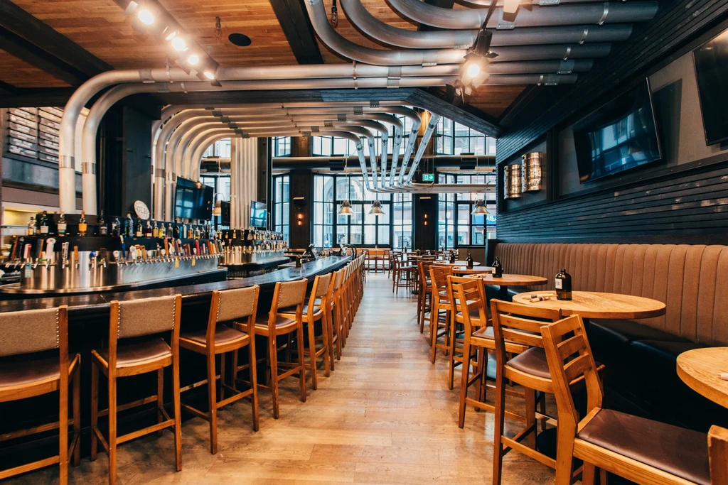 Empty modern industrial-chic bar and restaurant with curved pipes.