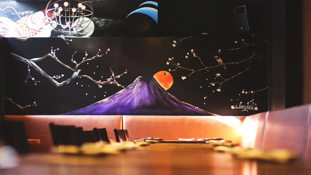 Restaurant wall mural of purple mountain, cherry blossoms, koi, and seating.