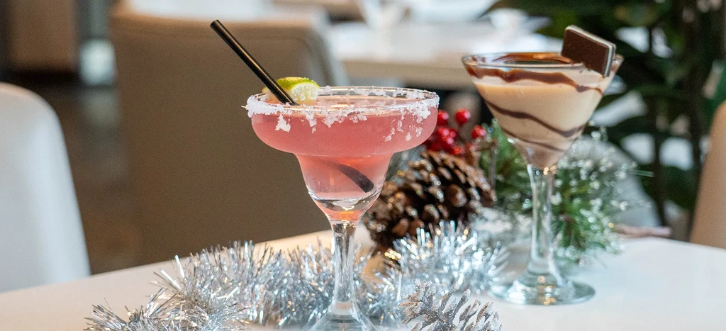 Two holiday cocktails: a pink margarita and a chocolate dessert martini.