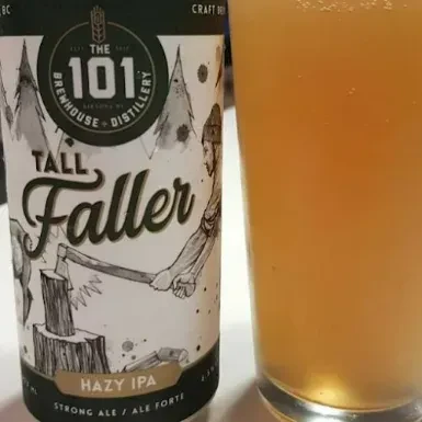Tall Faller Hazy IPA can and glass with lumberjack label.