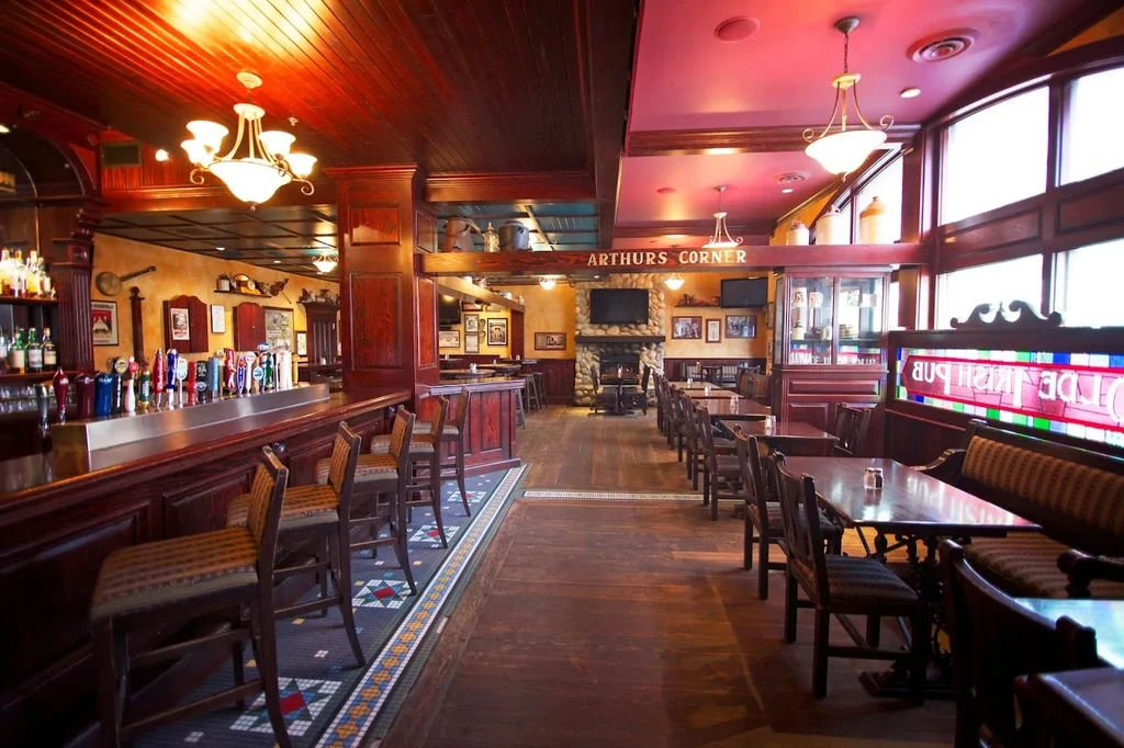Empty traditional Irish pub interior with bar and dining area.