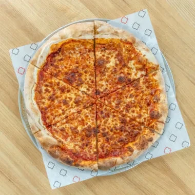 Whole cheese pizza, cut into eight slices, on a metal pan.