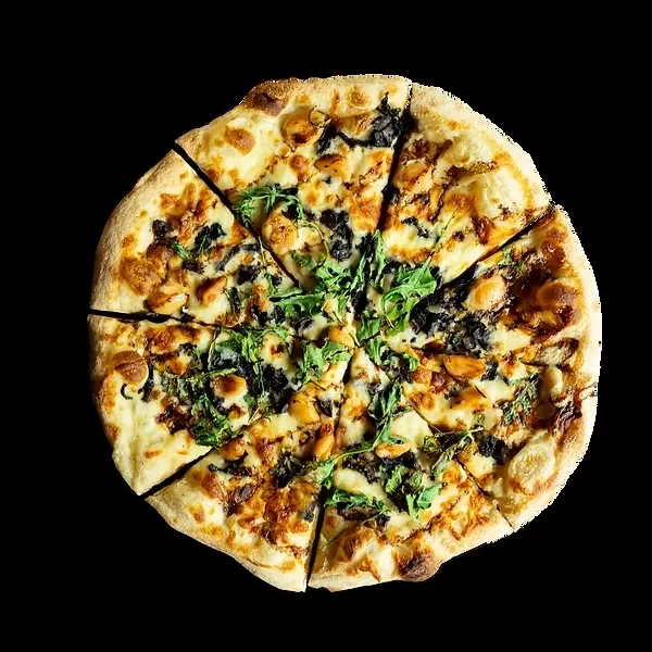 Freshly baked pizza with cheese, chicken, dark pieces, and arugula.