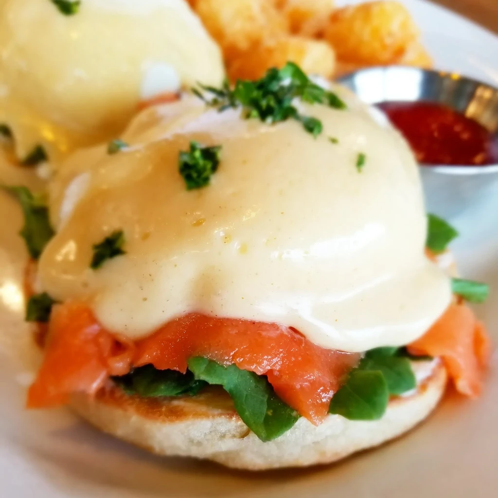 Smoked Salmon Eggs Benedict with poached egg, hollandaise, and tater tots.