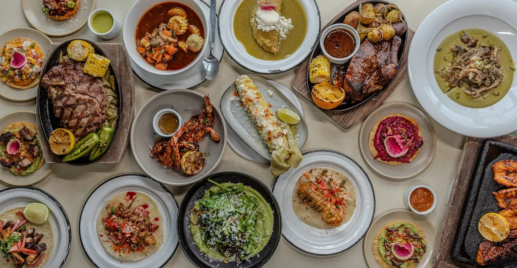 Overhead shot of a large spread of diverse Mexican and Latin American food.