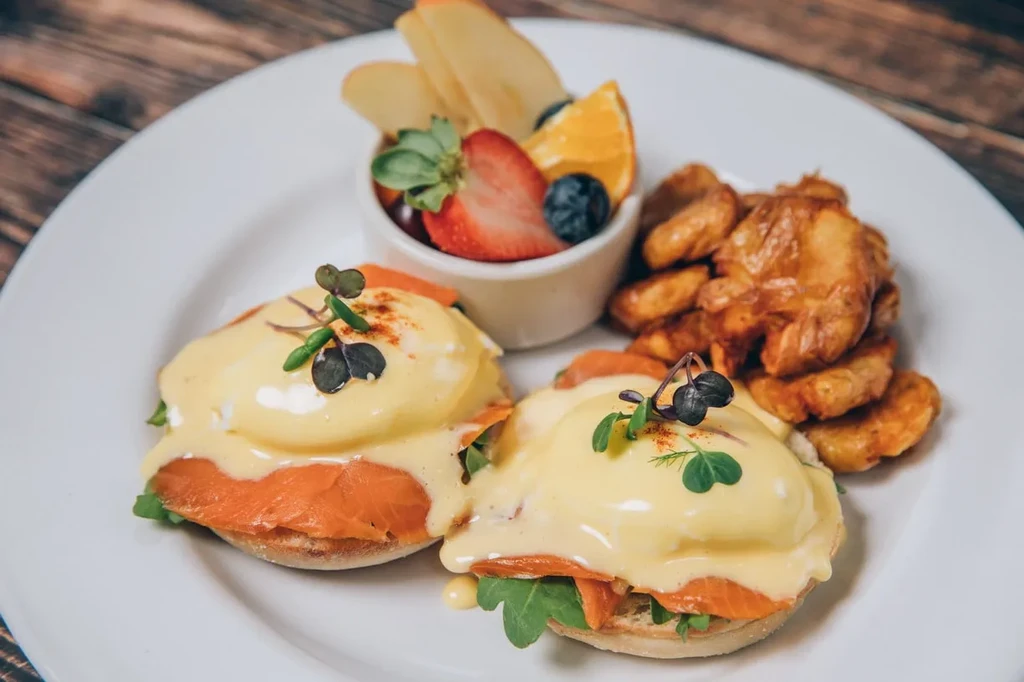 Smoked salmon Eggs Benedict, fruit medley, and roasted potatoes.
