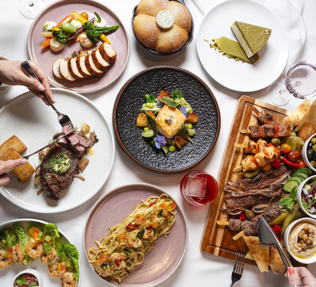 Top-down view: elegant dining table laden with various gourmet dishes.
