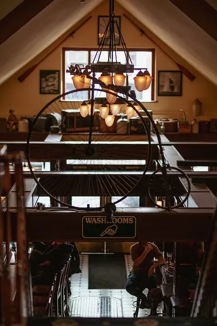 Multi-level restaurant with suspended antique penny-farthing bicycle chandelier.
