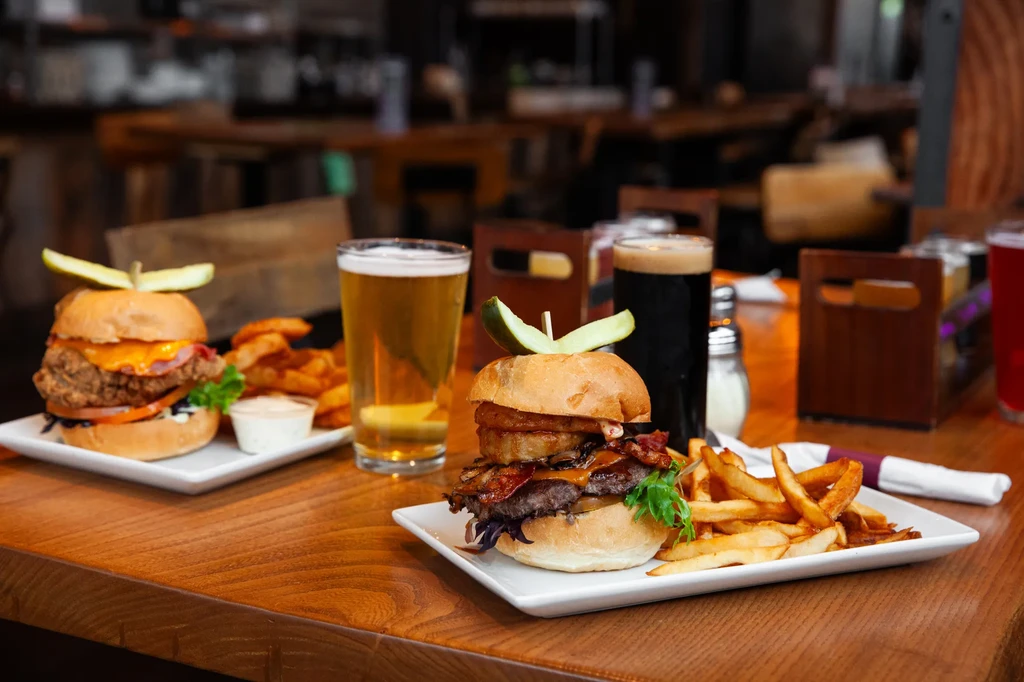 Two restaurant meals: burger, chicken sandwich, fries, and two beers.