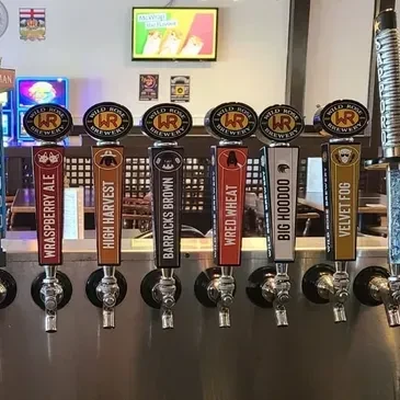 Seven Wild Rose Brewery beer taps displaying various beer names.