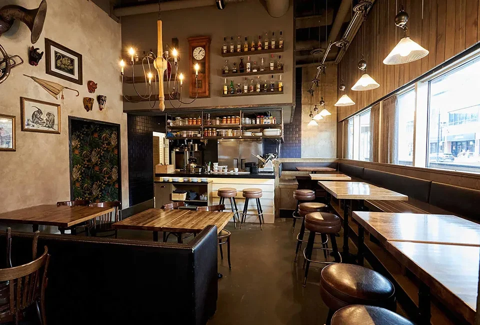 Rustic vintage industrial restaurant interior with bar and dining.
