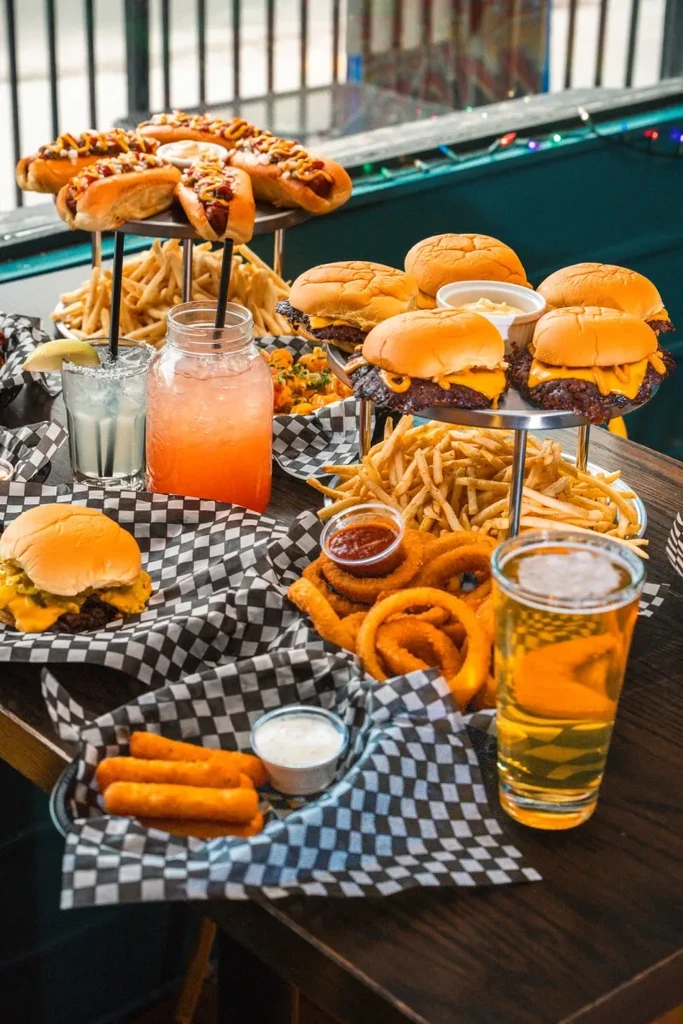 Overhead: large casual American diner food and drinks spread.