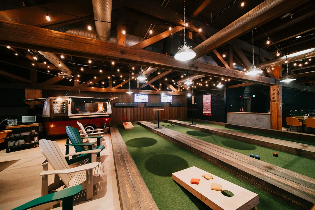 High-ceilinged venue with indoor bocce courts and a camper van bar.