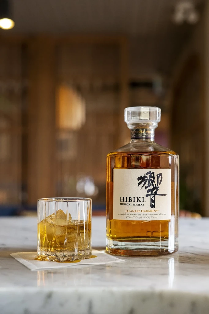 Hibiki Suntory Japanese Harmony whiskey bottle and glass with ice.