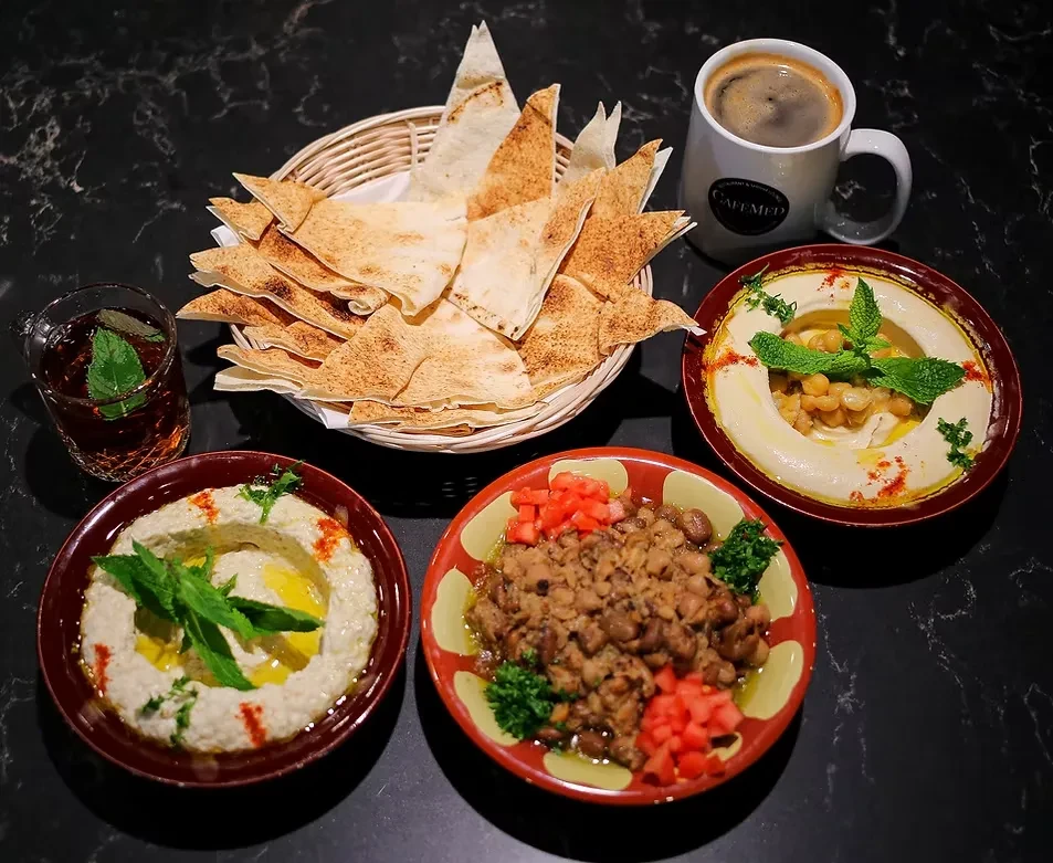 Cafe Med spread of pita, hummus, beans, coffee, and tea.