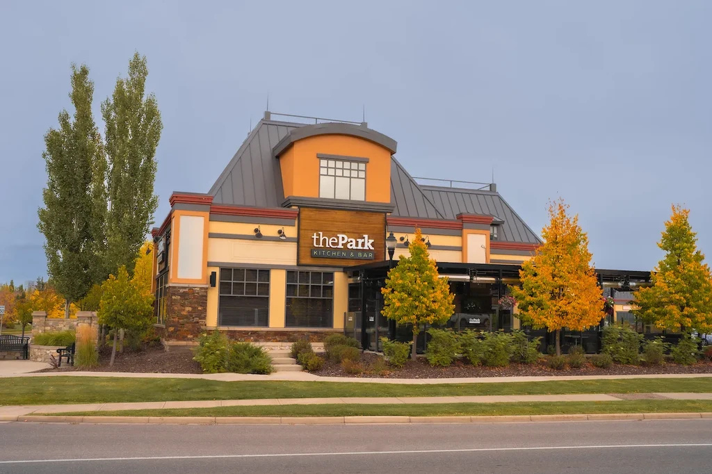 Modern restaurant 'the Park KITCHEN & BAR' with colorful fall foliage.