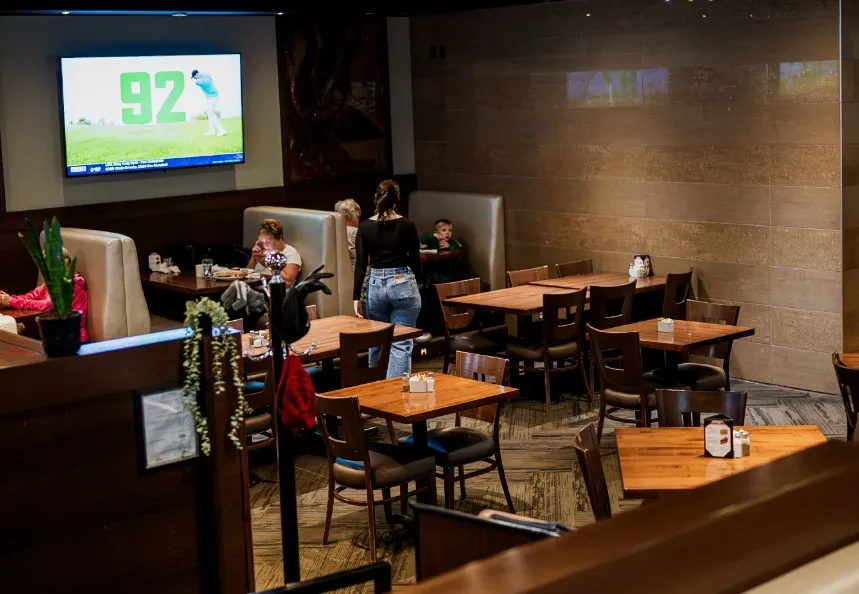 Casual modern restaurant interior with tables, booths, and patrons.