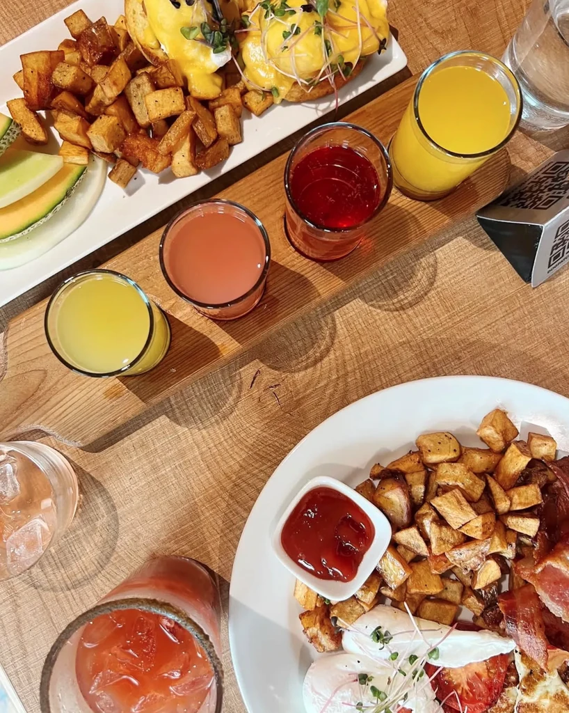 Restaurant table with assorted breakfast and brunch plates and drinks.