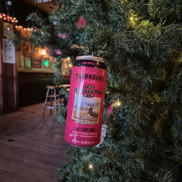 Red Tragically Hip cider can ornament on a lit Christmas tree.