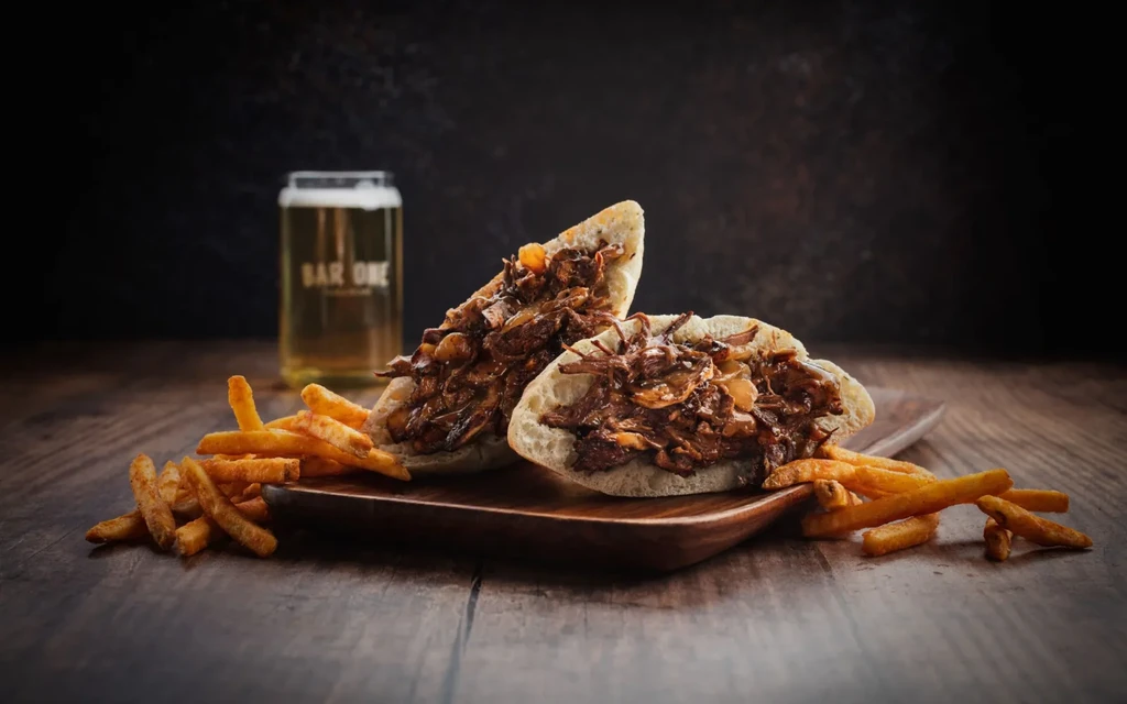 Pulled meat pita sandwich with fries and a BAR ONE beer.