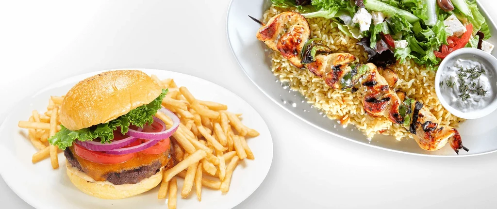 Cheeseburger and fries, chicken skewer with rice and salad.