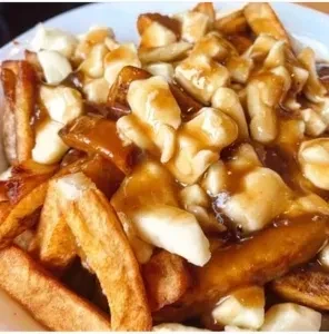 Poutine with golden fries, rich gravy, and white cheese curds.