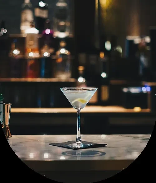 A chilled martini glass with lemon twist and sugared rim on marble.