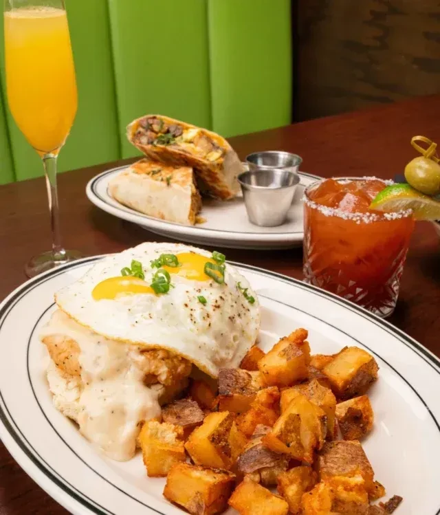 Restaurant brunch: Fried chicken, eggs, home fries, burrito, Mimosa, Bloody Mary.