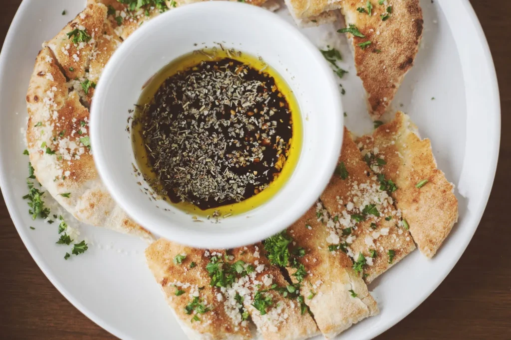 Golden focaccia, cheese, herbs, and herbed olive oil dip.